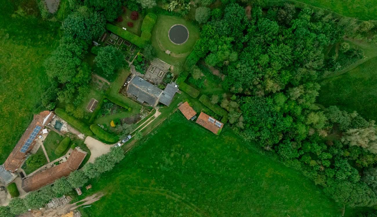 Looking from above - The Granary is the property next to the one with solar panels and the woodland is on the right hand side of the photo, beyond the owners' home.