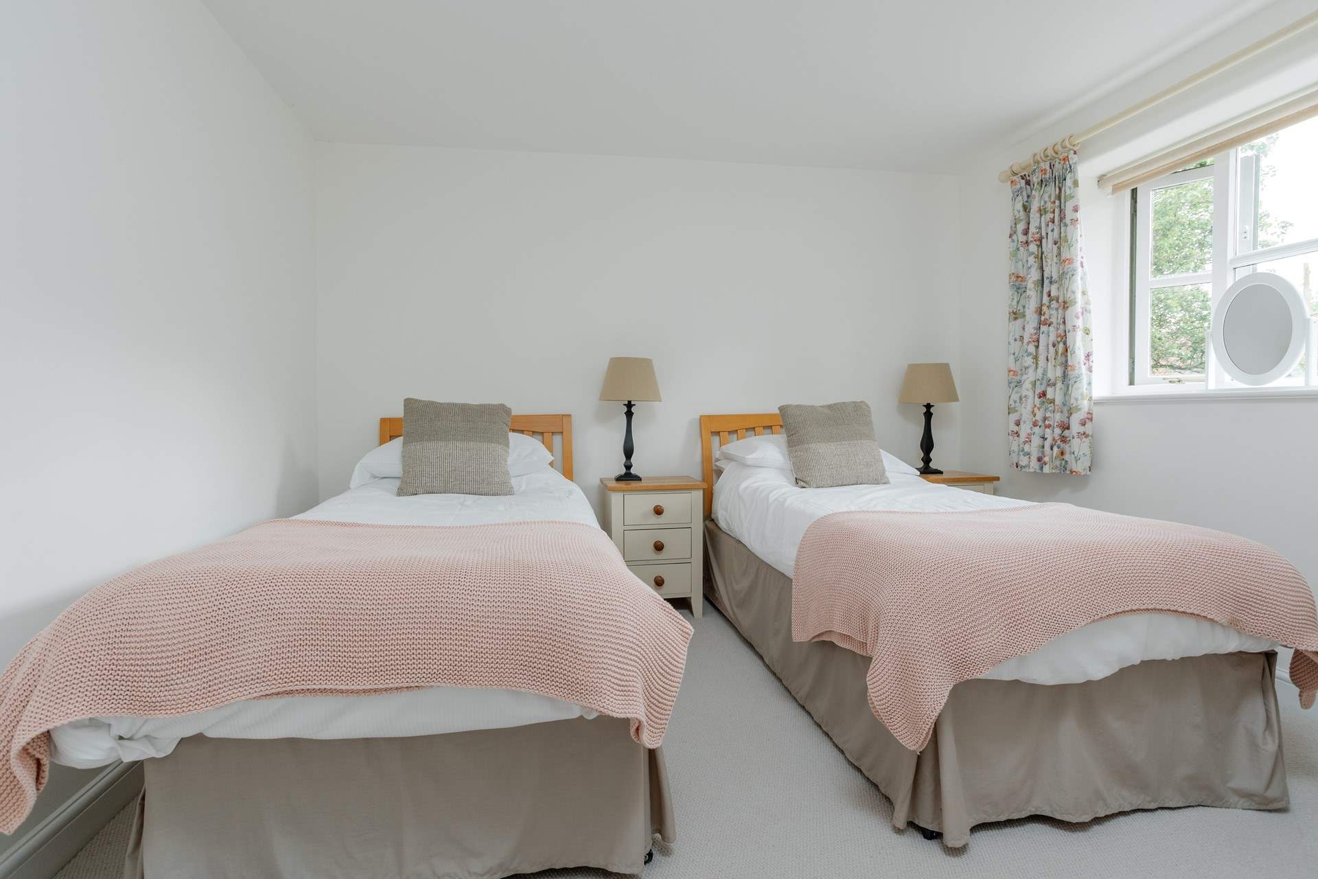 Twin beds offer great flexibility for children and adults alike. There is a wardrobe out of shot.