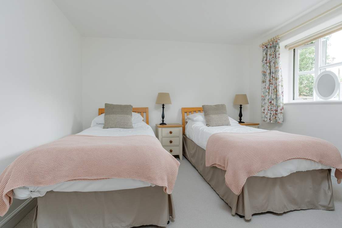 Twin beds offer great flexibility for children and adults alike. There is a wardrobe out of shot.