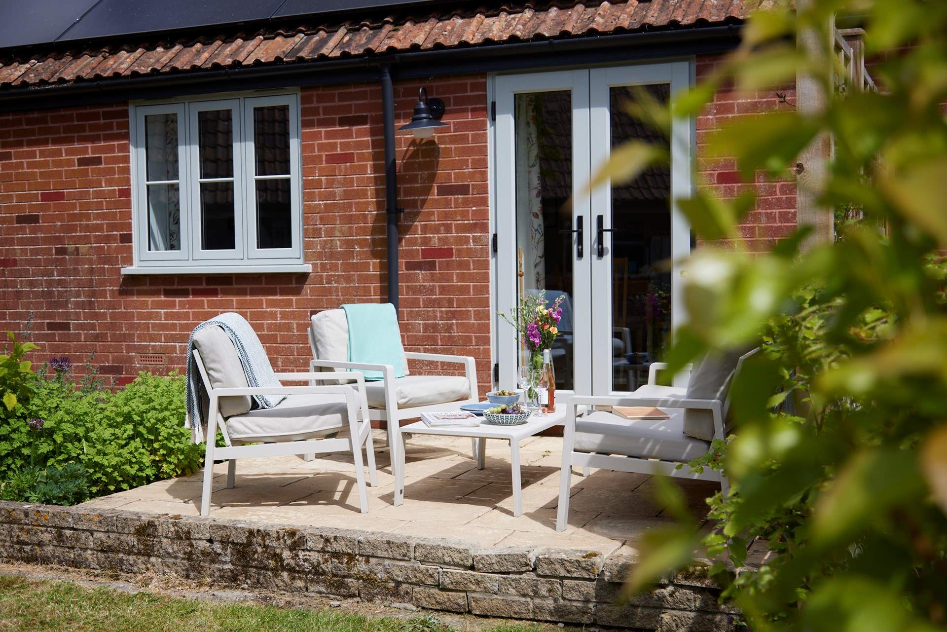 The seating and dining area is a lovely sheltered sun trap - perfect for some al fresco dining and socialising.