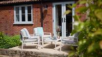 The seating and dining area is a lovely sheltered sun trap - perfect for some al fresco dining and socialising.