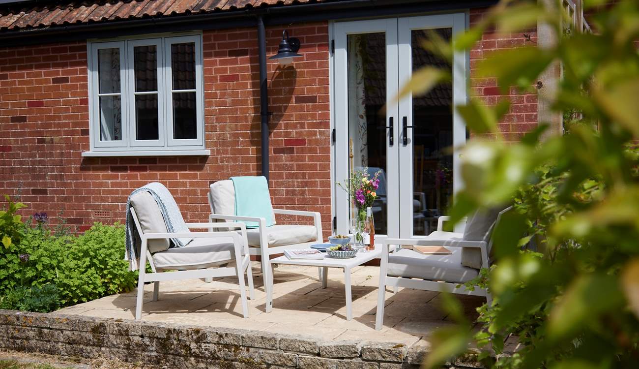 The seating and dining area is a lovely sheltered sun trap - perfect for some al fresco dining and socialising.