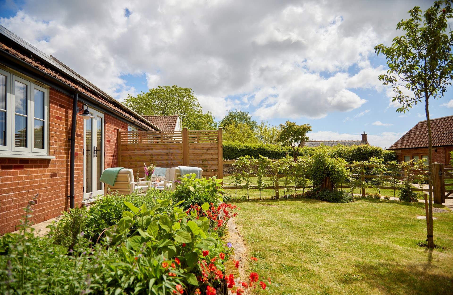 The beautiful private garden has a lovely secluded seating and dining area