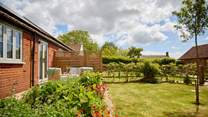 The beautiful private garden has a lovely secluded seating and dining area