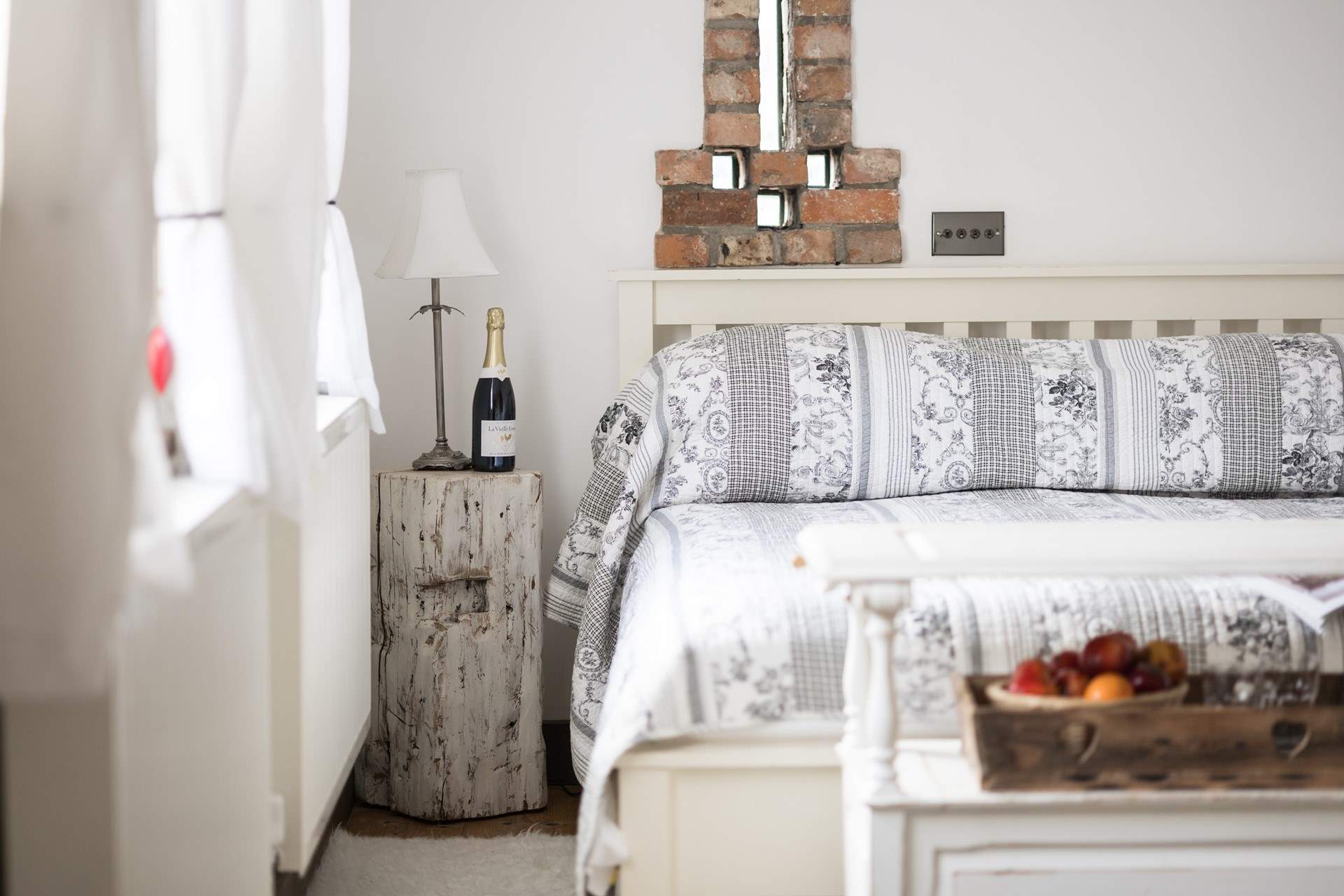 The ground floor bedroom is so pretty with original brickwork too.