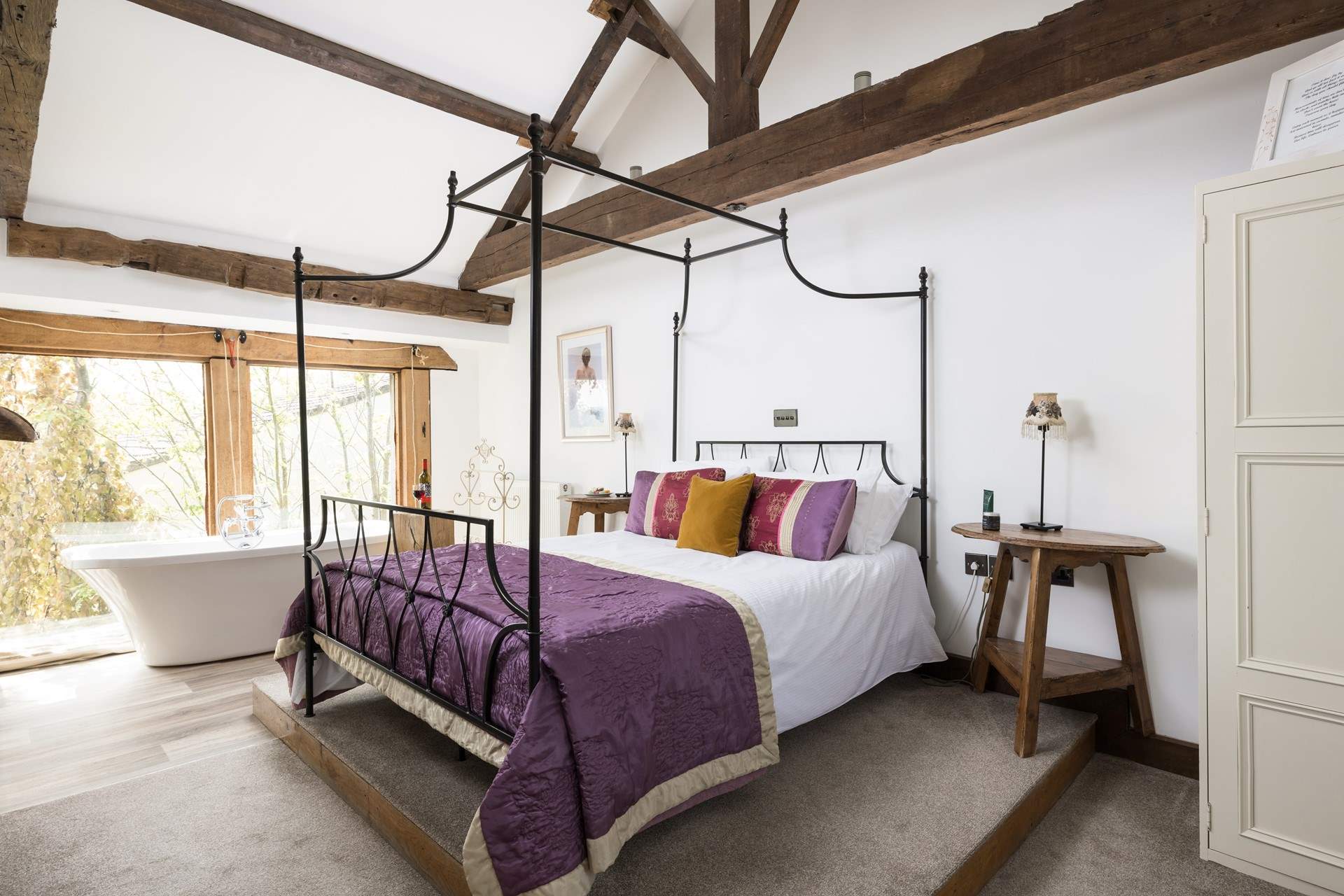 A spacious king-size bedroom. A TV and free-standing bath feature too!