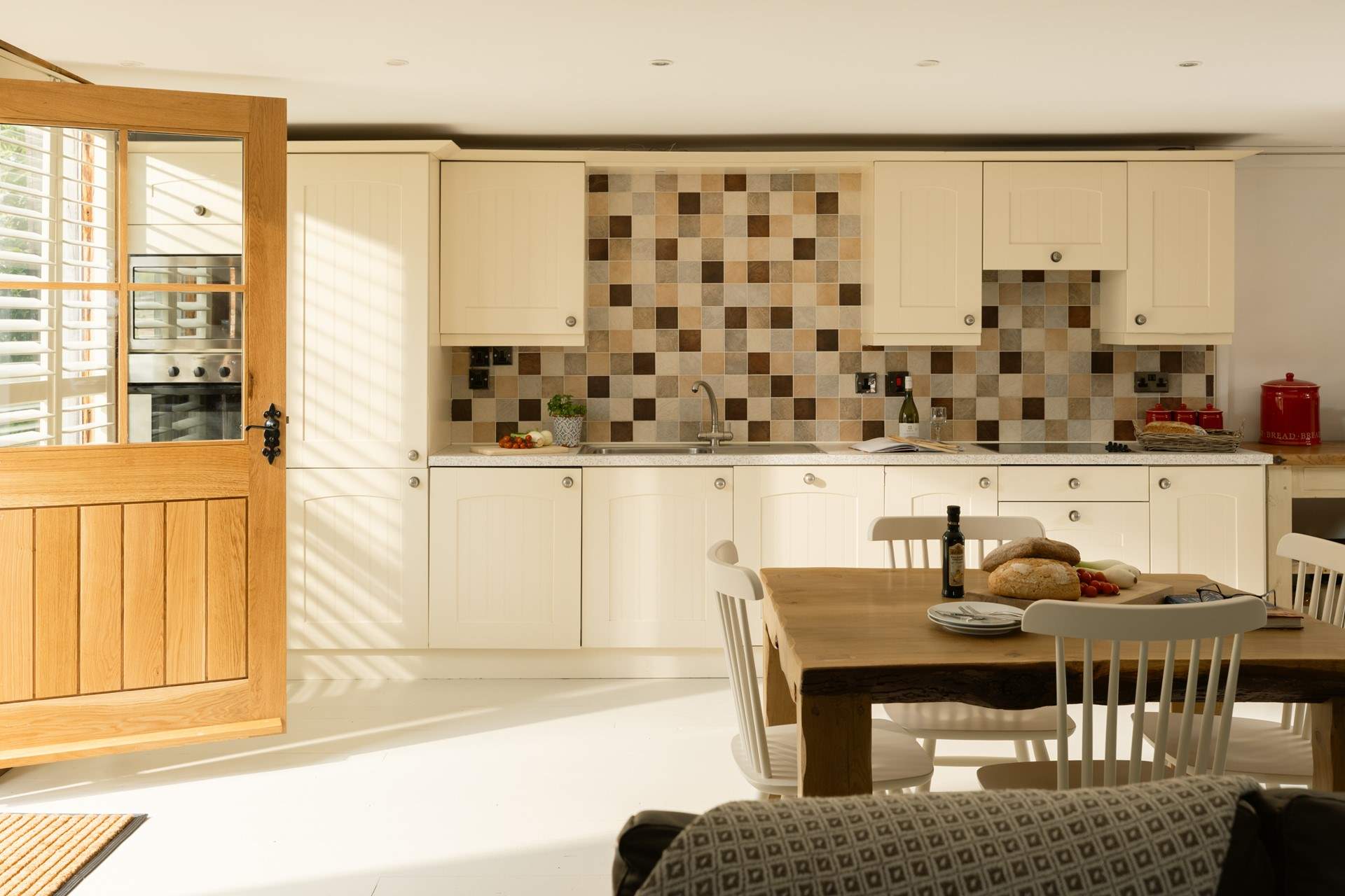 Spacious kitchen dining area with doors through to the garden.
