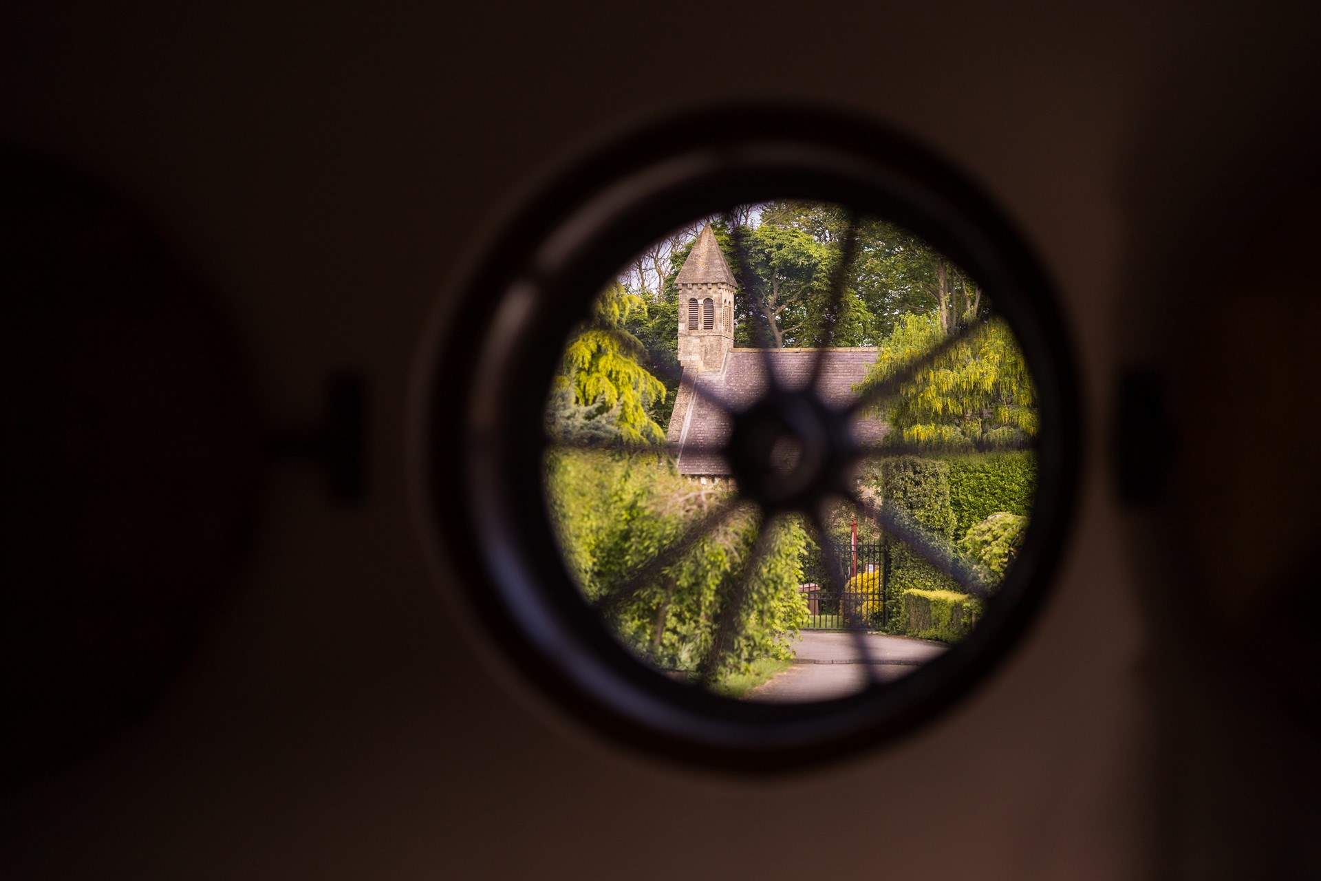 The gates to the cottages with the church sitting beyond.