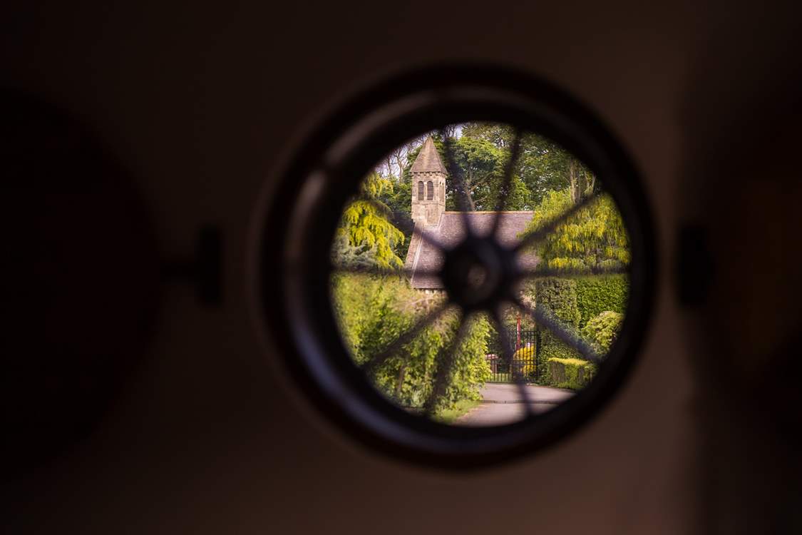 The gates to the cottages with the church sitting beyond.
