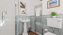 The family bathroom is fully equipped with a shower cubicle and bath.