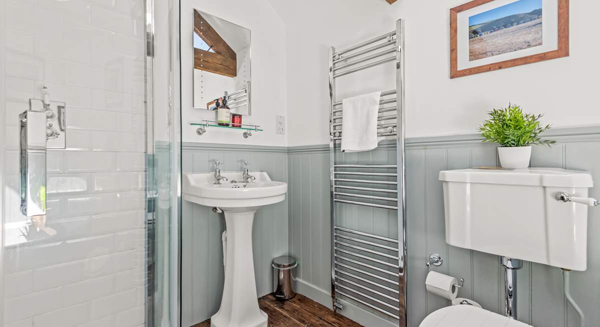 The family bathroom is fully equipped with a shower cubicle and bath.