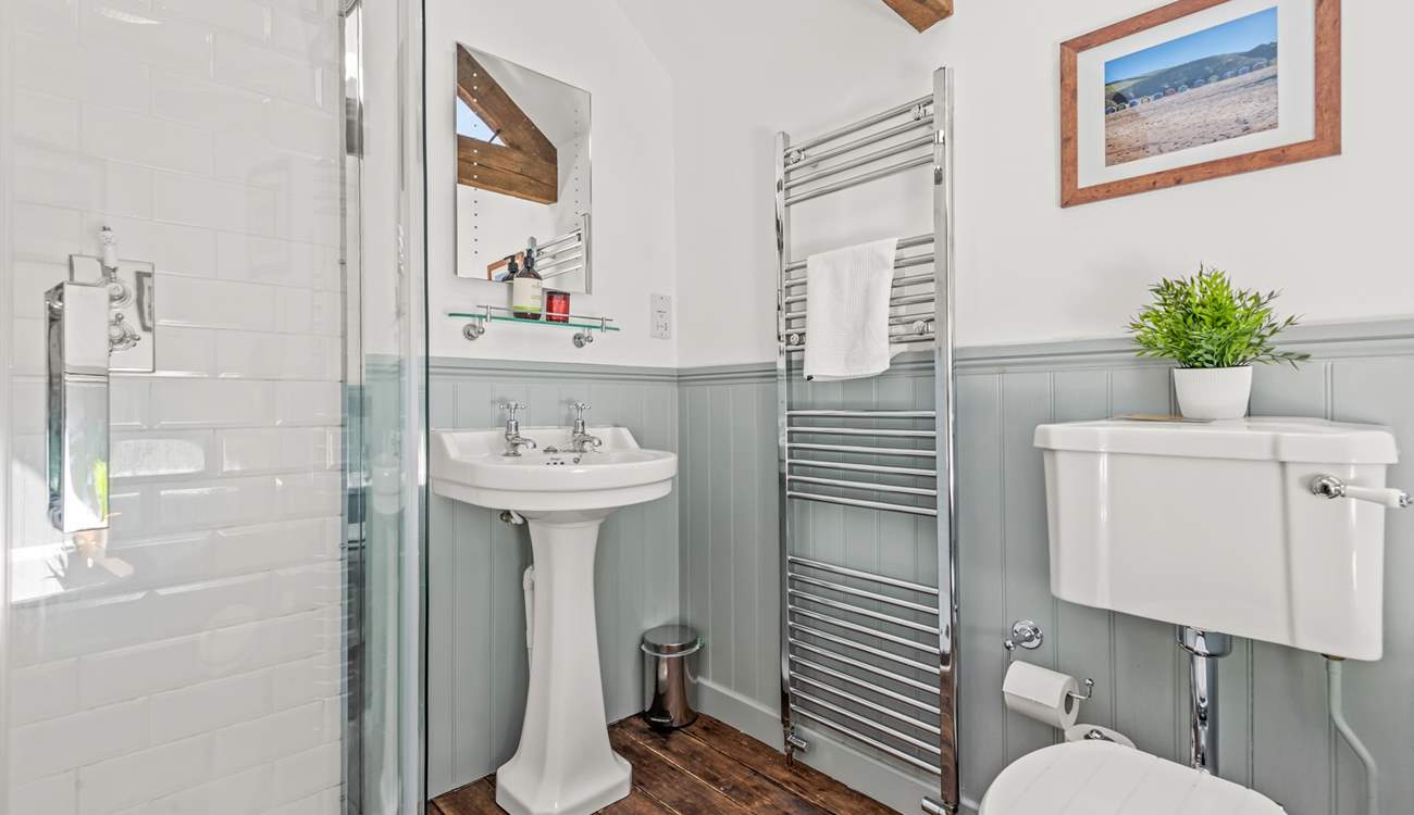 The family bathroom is fully equipped with a shower cubicle and bath.