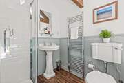 The family bathroom is fully equipped with a shower cubicle and bath.