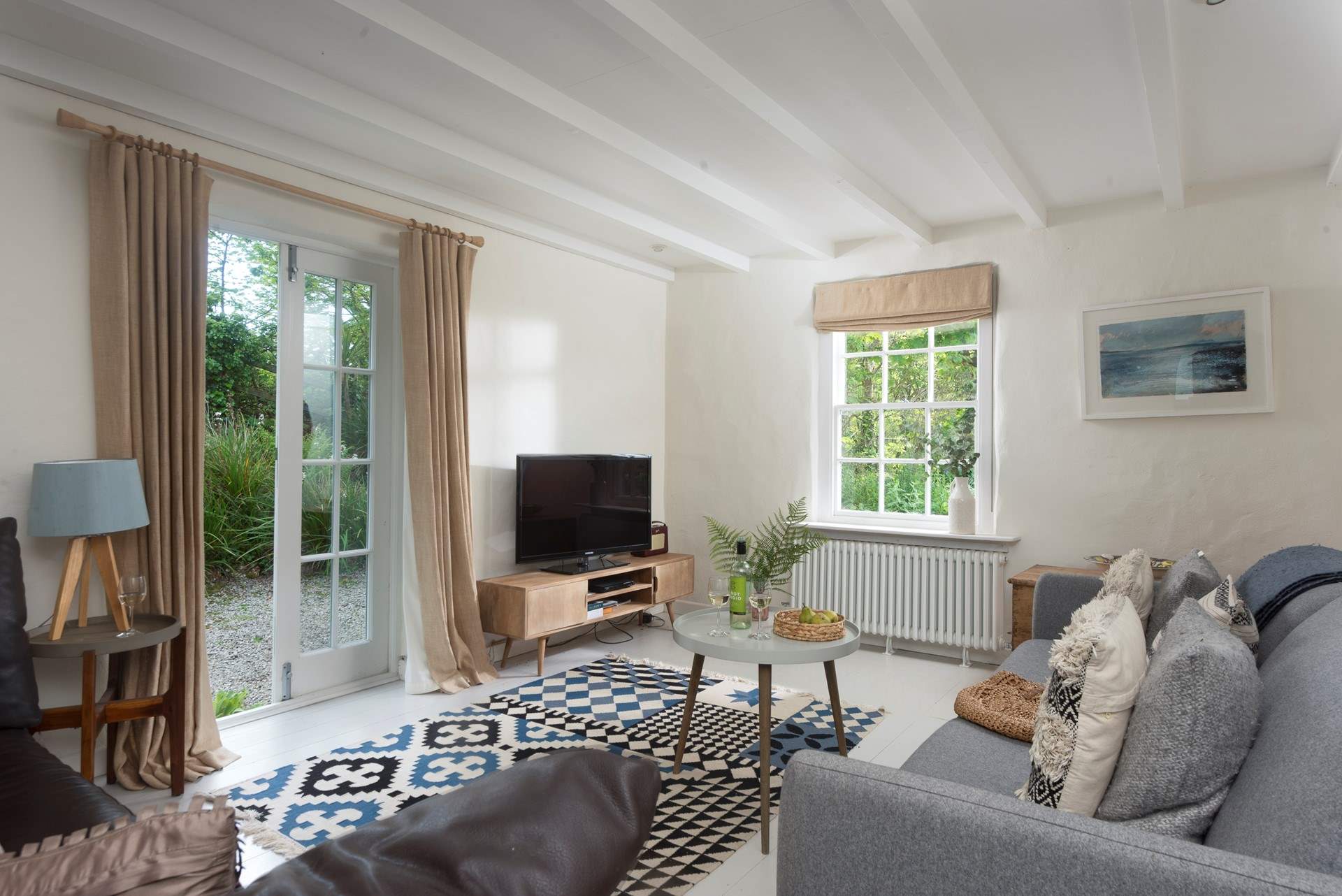 This gorgeous sitting-room  is one of three and has double door access to the beautiful grounds.