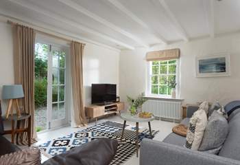 This gorgeous sitting-room  is one of three and has double door access to the beautiful grounds.
