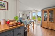 The kitchen and dining areas open out onto your patio.