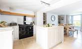 The gorgeous kitchen has an Aga which adds to the cosiness of this lovely seaside retreat. - Thumbnail Image