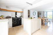 The gorgeous kitchen has an Aga which adds to the cosiness of this lovely seaside retreat.