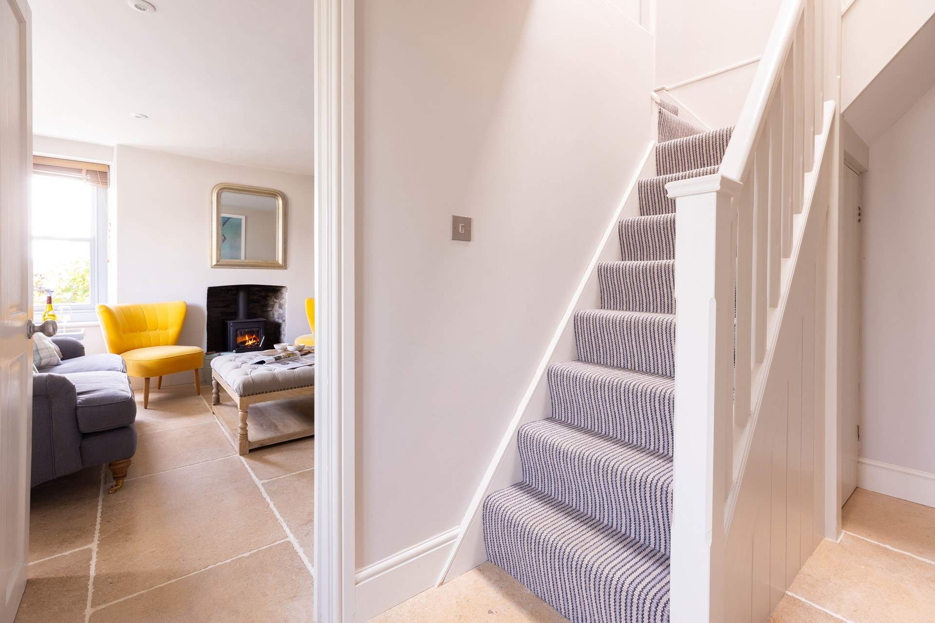 The steep cottage staircase leads up the bedrooms.