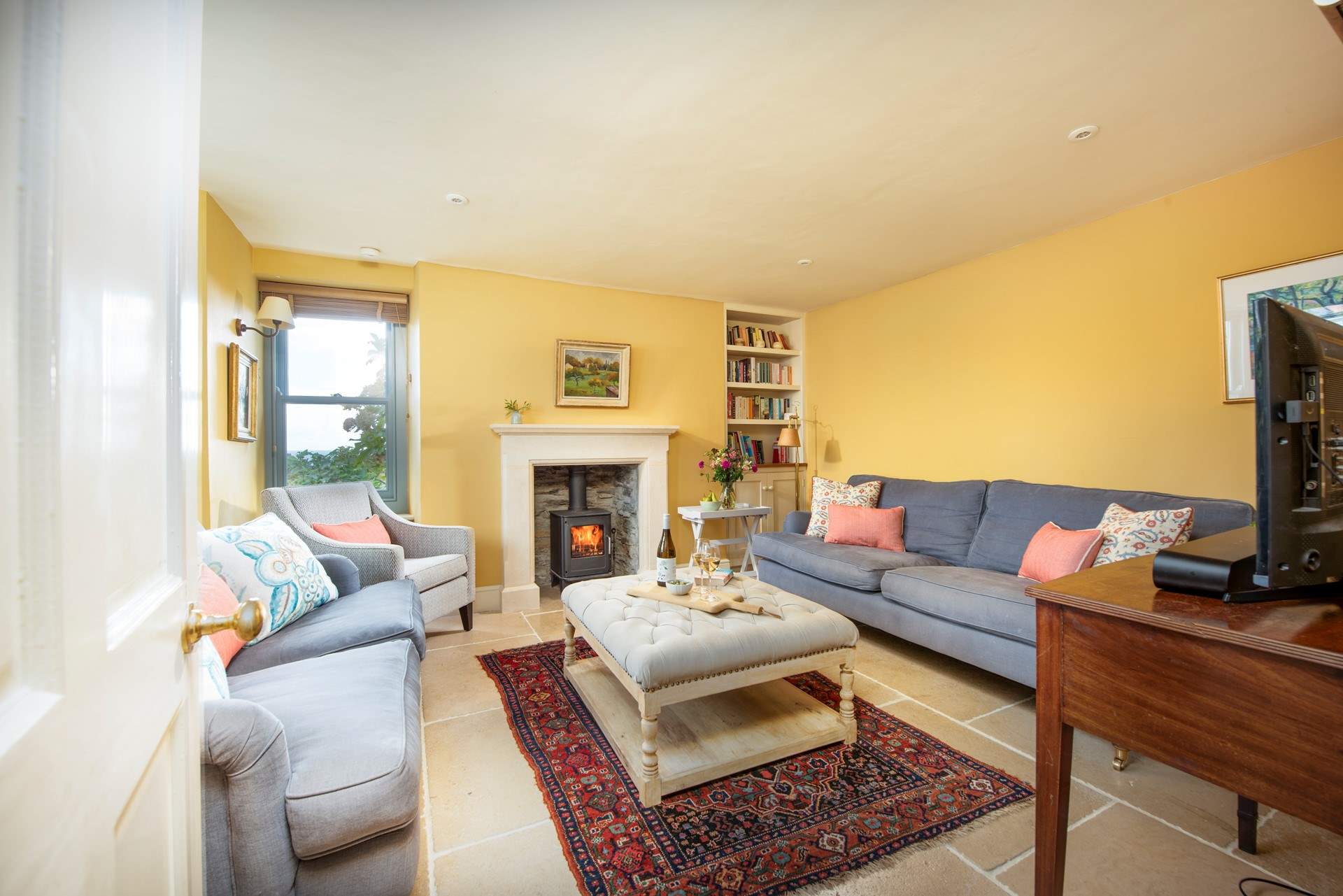 The cosy sitting-room on the ground floor has a wood-burner to keep you warm throughout the seasons. 