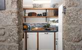 Granite stone walls lead to the stylish and very well-equipped kitchen. - Thumbnail Image