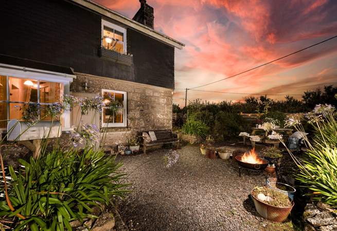 Warm yourself by the firepit in the charming garden.