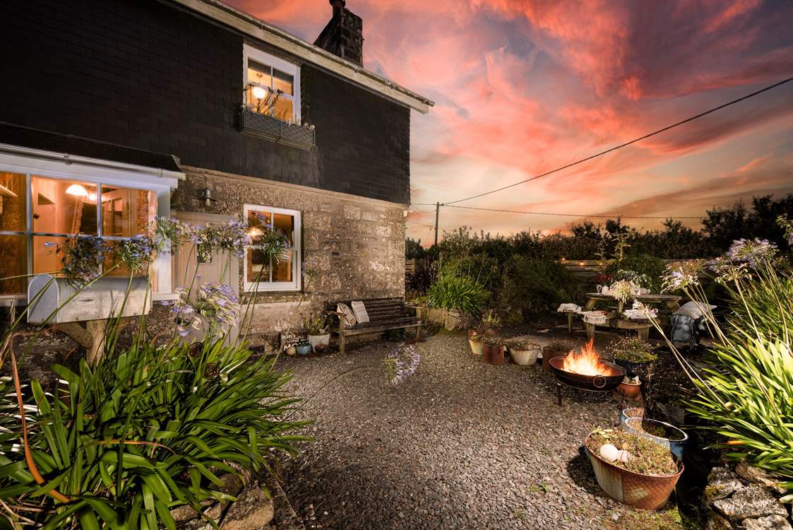 Warm yourself by the firepit in the charming garden.