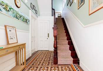 Steps in the communal hallway lead up to the front door of the apartment.