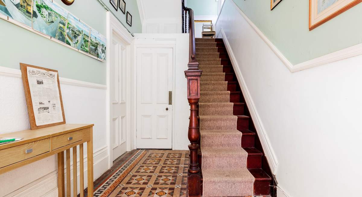 Steps in the communal hallway lead up to the front door of the apartment.