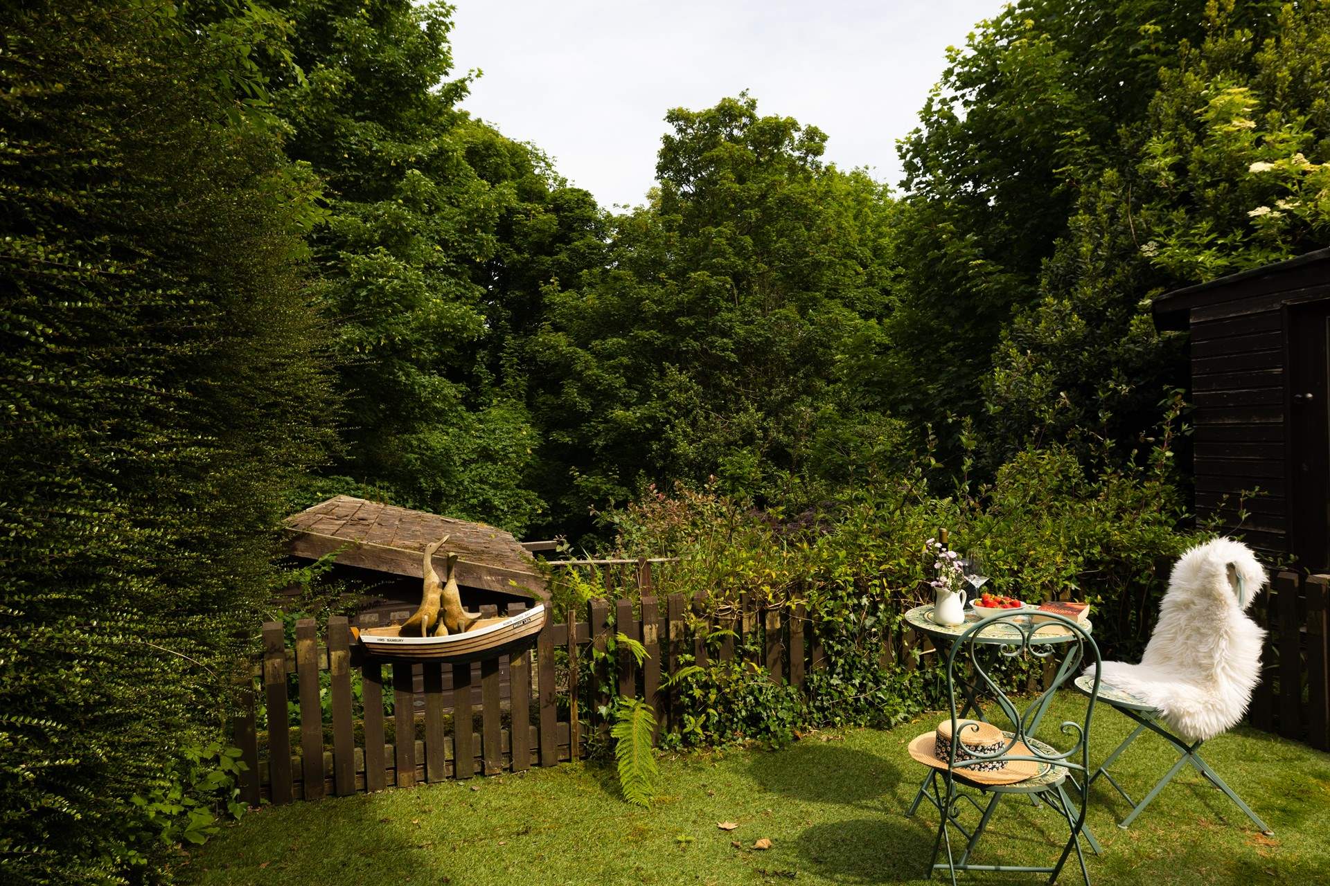 The garden is surrounded by mature trees.