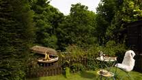 The garden is surrounded by mature trees.