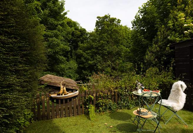 The garden is surrounded by mature trees.