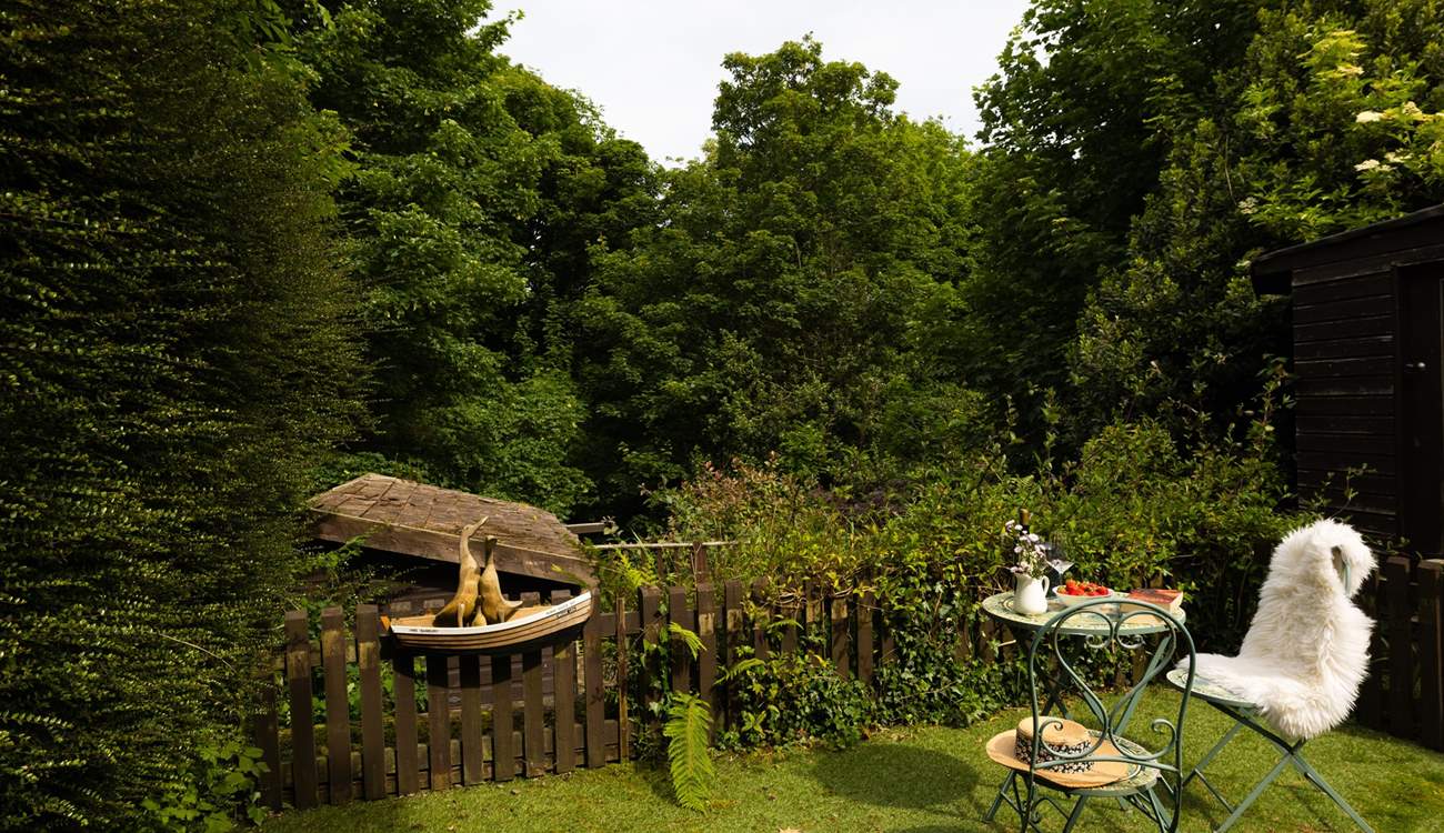 The garden is surrounded by mature trees.