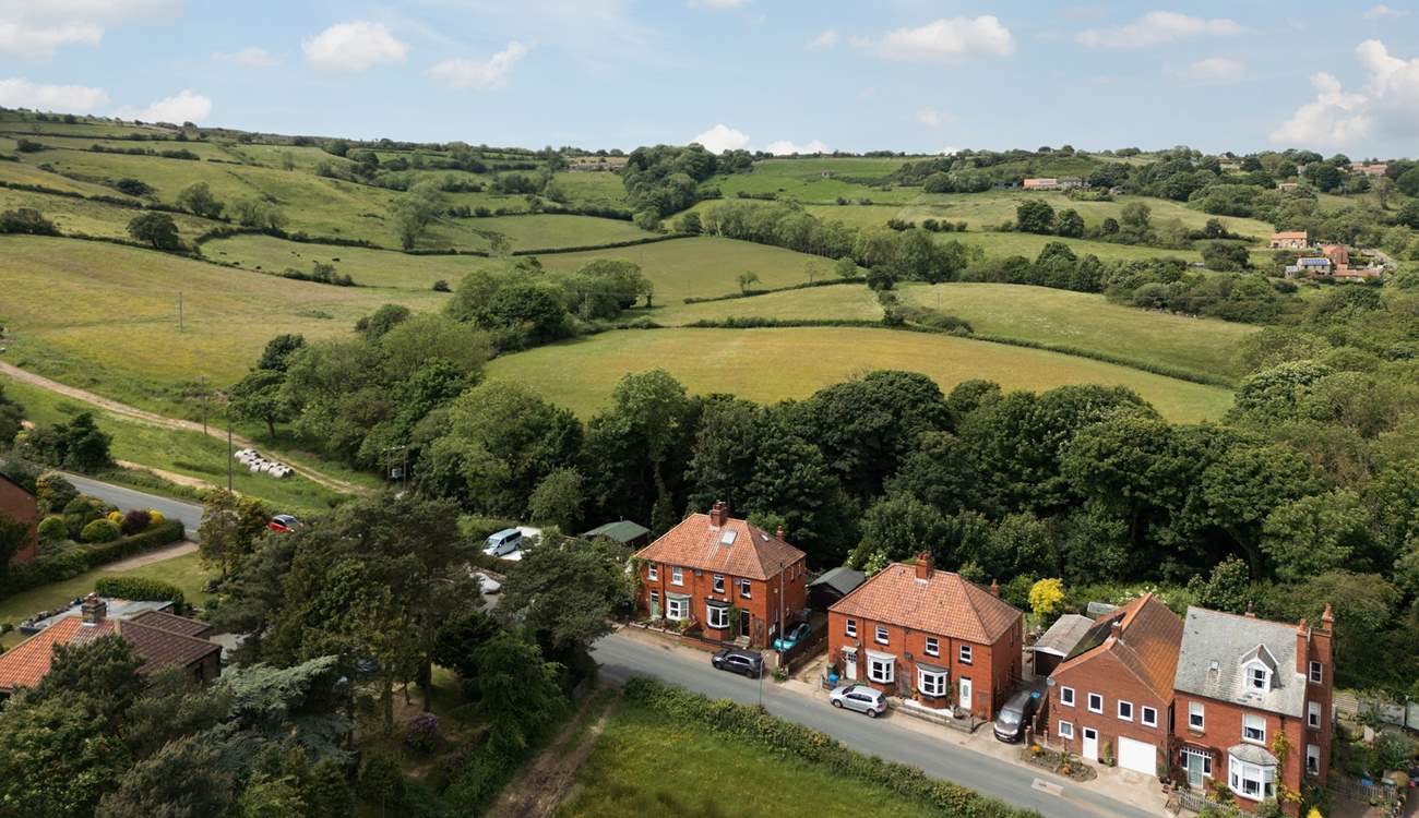 Briar Lea is set in the rolling hills close to the seaside villages of Robin Hood's Bay and Whitby. it is the property seen here with the black front door and dark grey car parked in front.