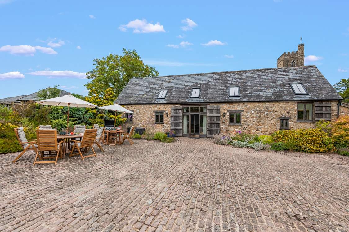 What a beautiful building and charming spot, with the stunning village church in the background.