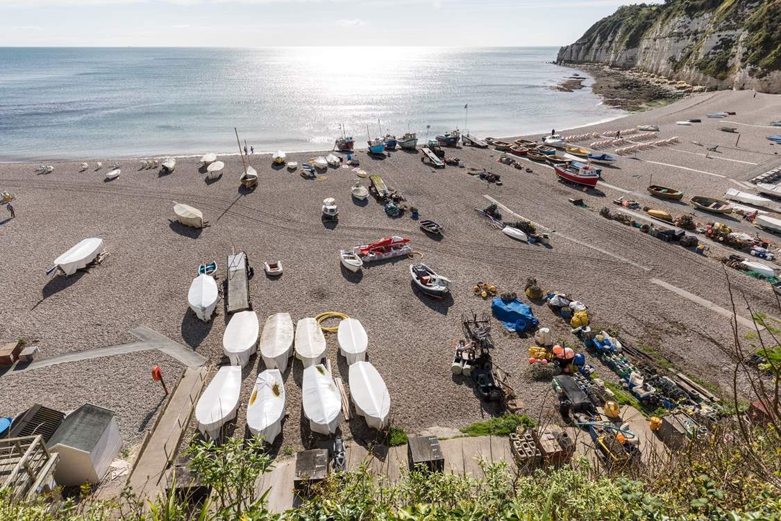 Numerous watercraft resting on the beautiful beach at Beer.
