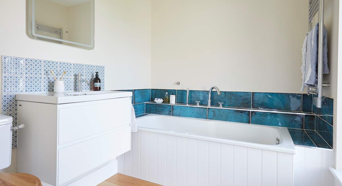 The en suite bathroom is the perfect spot to relax in after a busy day.