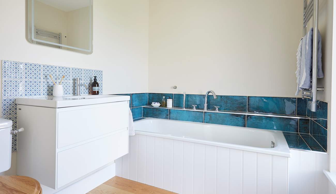 The en suite bathroom is the perfect spot to relax in after a busy day.