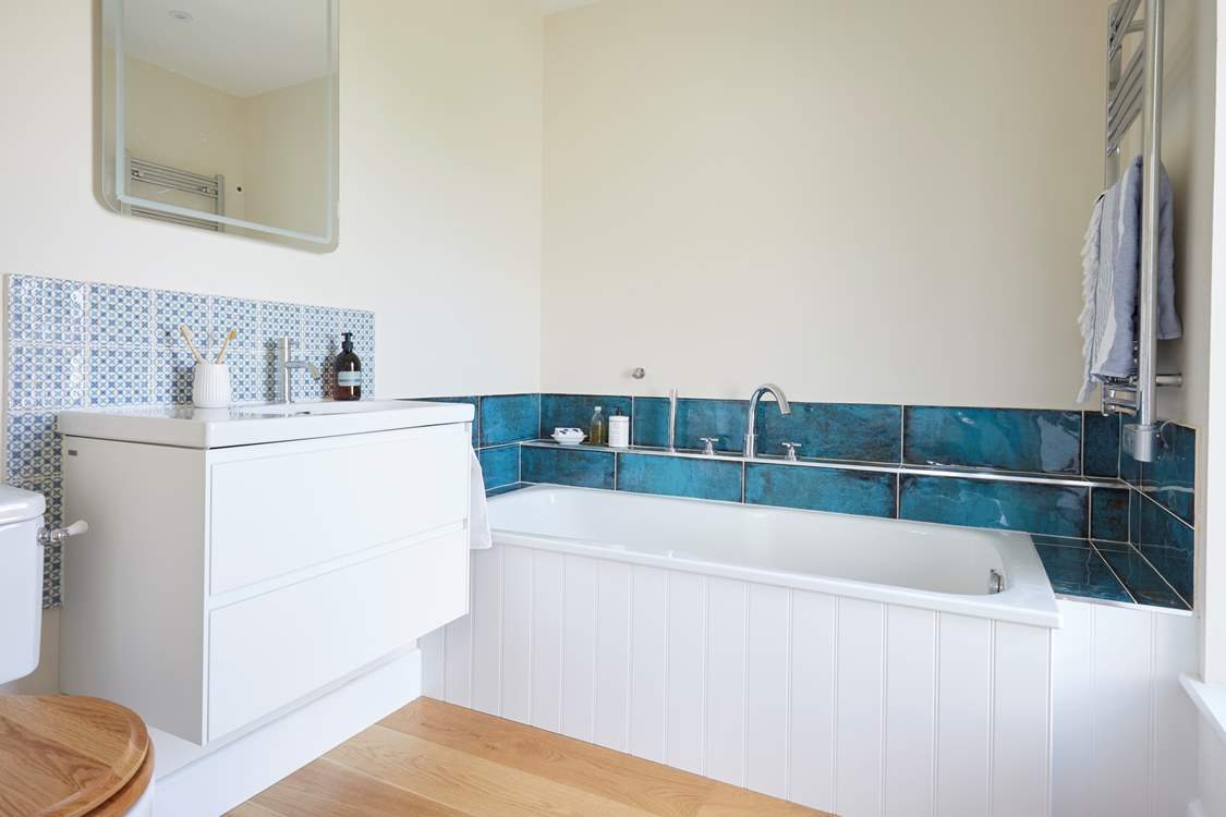 The en suite bathroom is the perfect spot to relax in after a busy day.