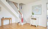 The bright hallway leads into the living space and up to the bedrooms. - Thumbnail Image