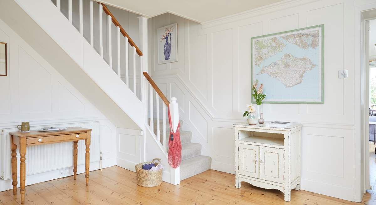 The bright hallway leads into the living space and up to the bedrooms.