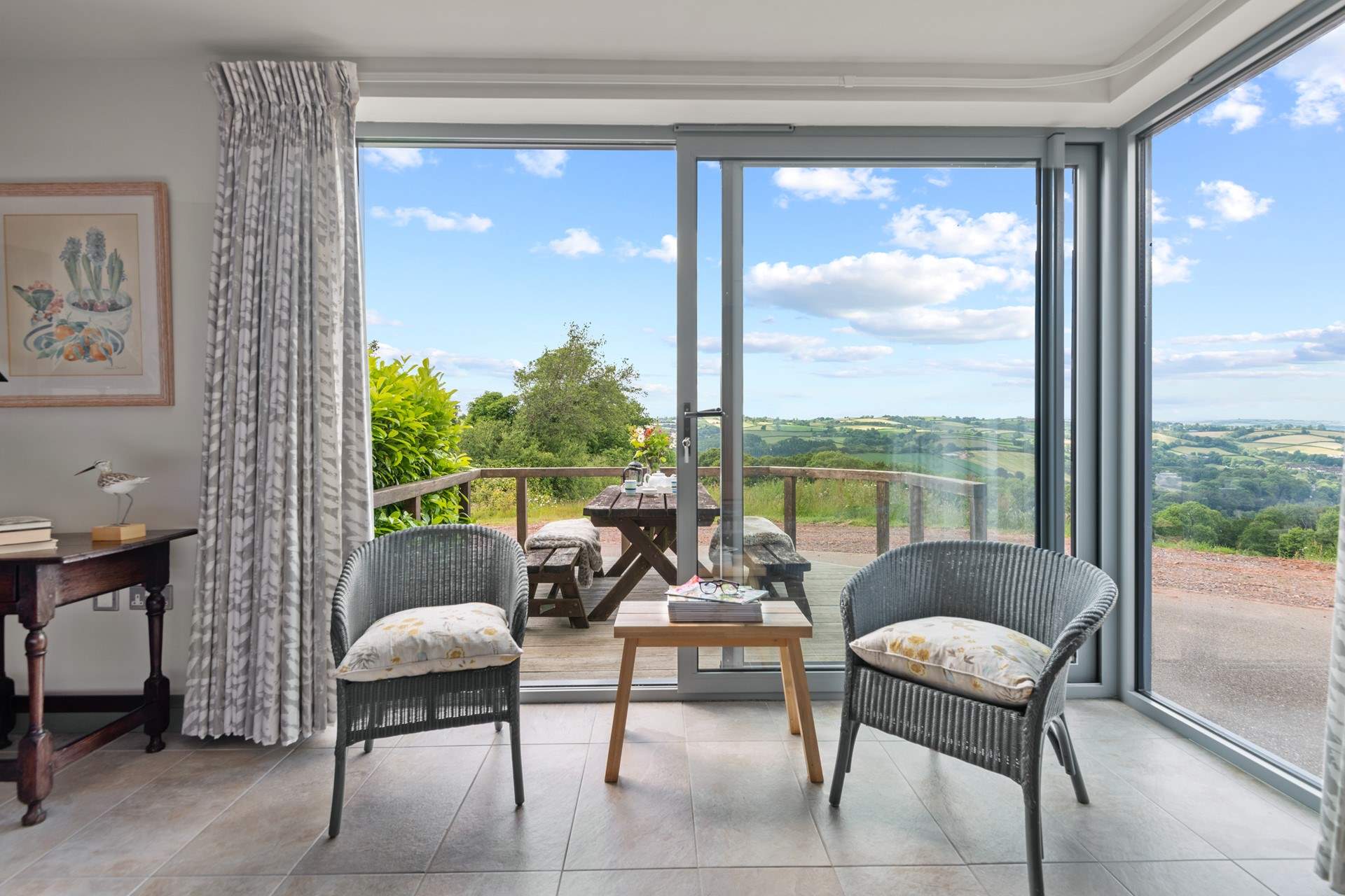 Step out of bedroom 1 onto the lower decked area. Perfect place to enjoy your morning coffee.