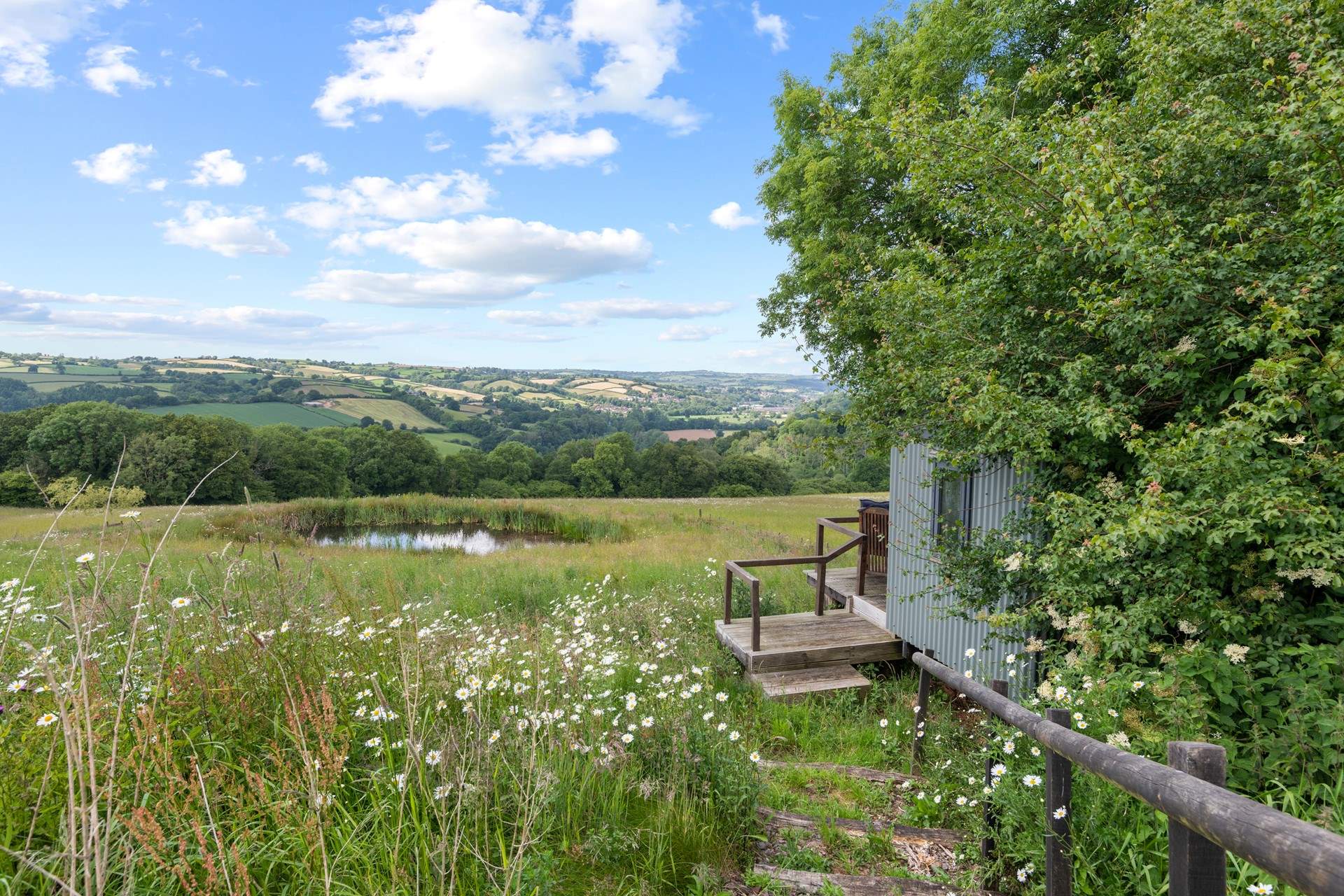 The summer-house is cleverly tucked away in the hedgerow.