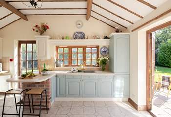 The beamed ceiling and patio doors add charm to this lovely kitchen.