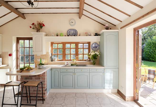 The beamed ceiling and patio doors add charm to this lovely kitchen.