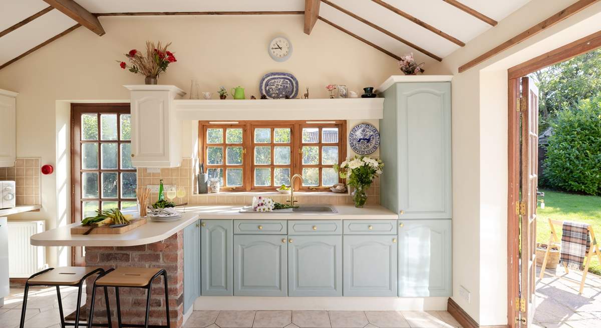 The beamed ceiling and patio doors add charm to this lovely kitchen.