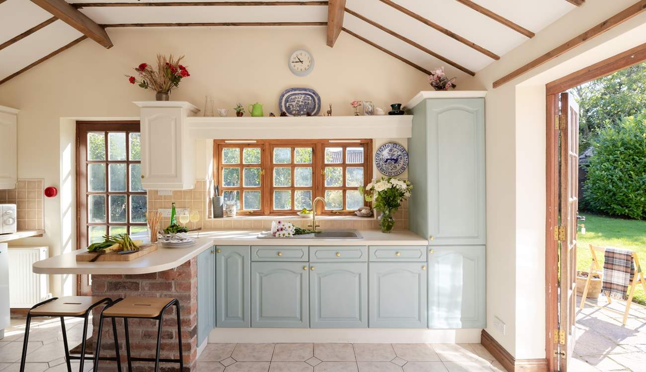 The beamed ceiling and patio doors add charm to this lovely kitchen.