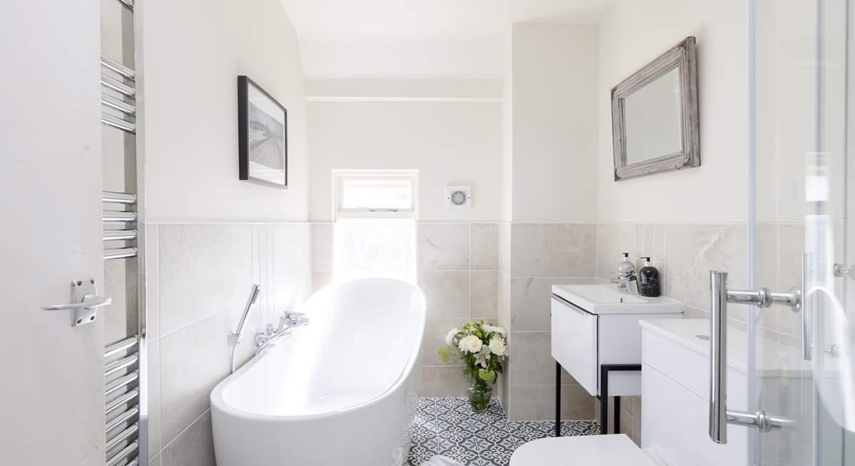 The sumptuous family bathroom has everything you need to relax after a day by the sea.