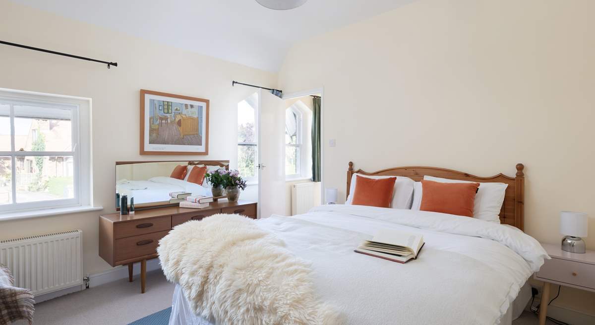 Another bright and airy bedroom with king-size bed and more original windows.