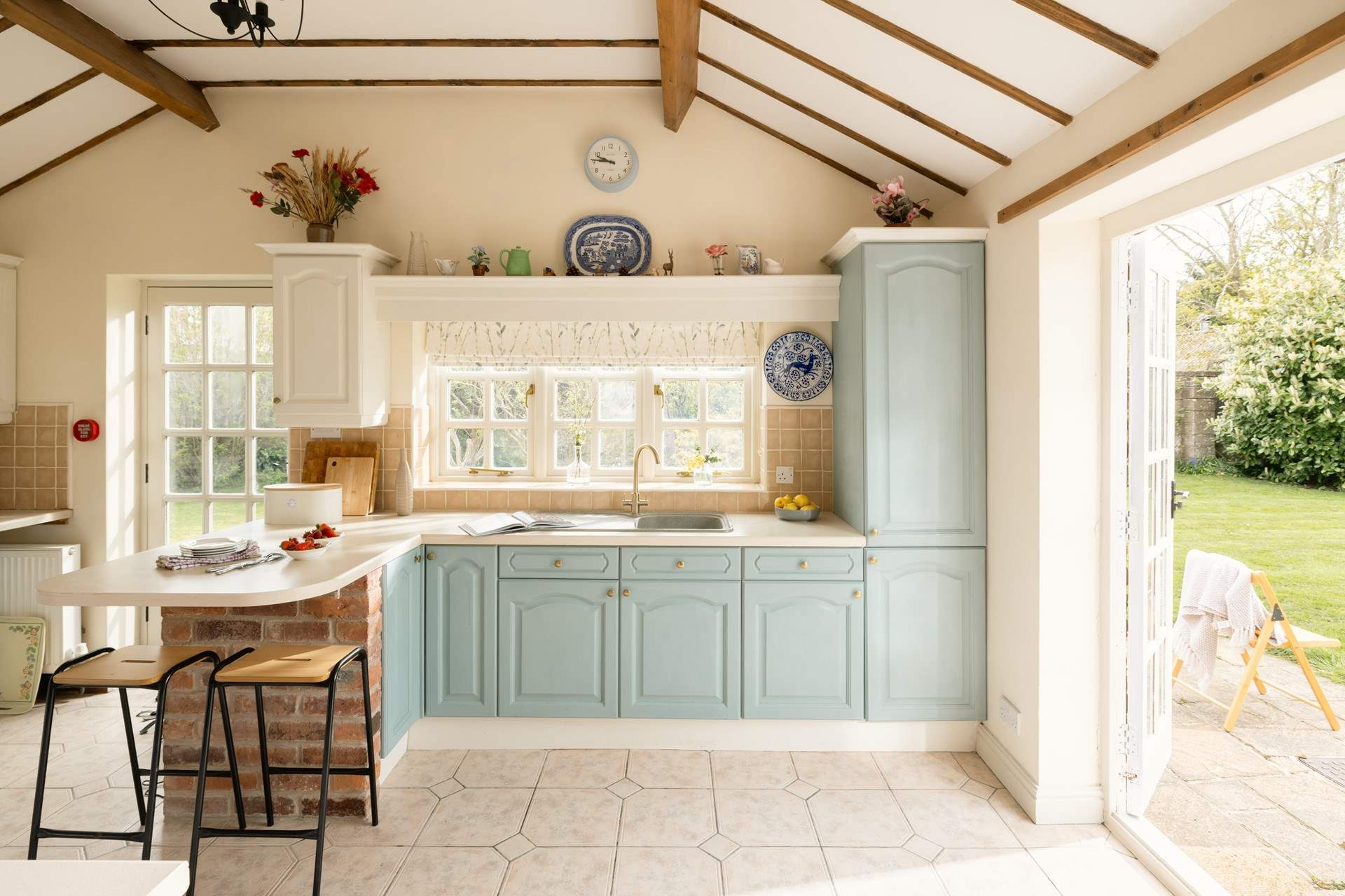 The beamed ceiling and patio doors add charm to this lovely kitchen.